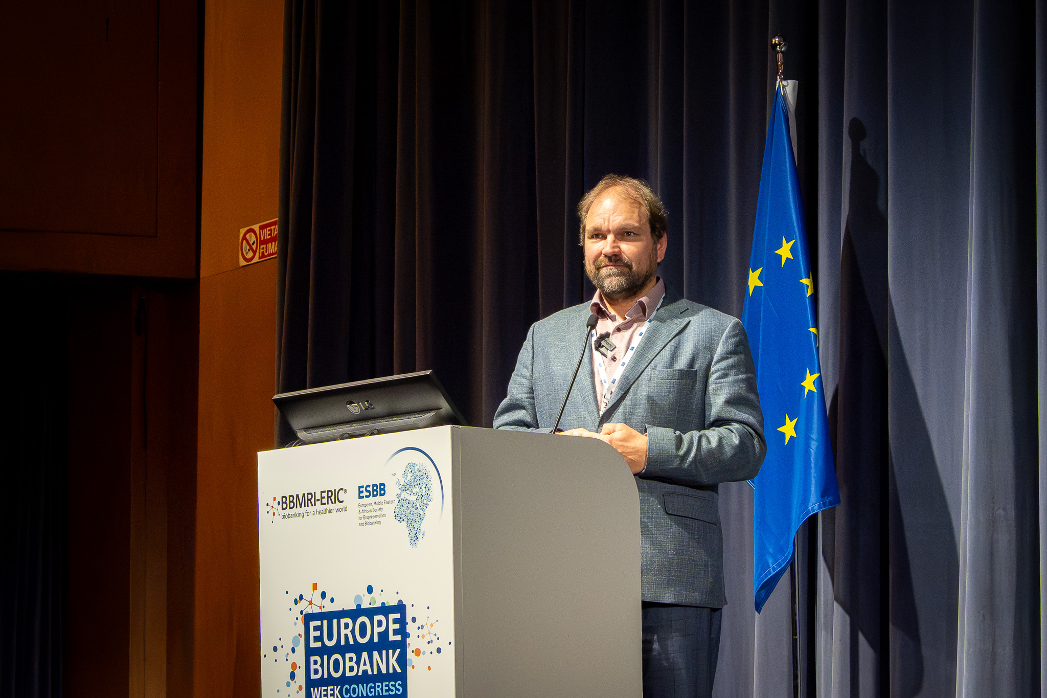 the picture of a man speaking from a stage