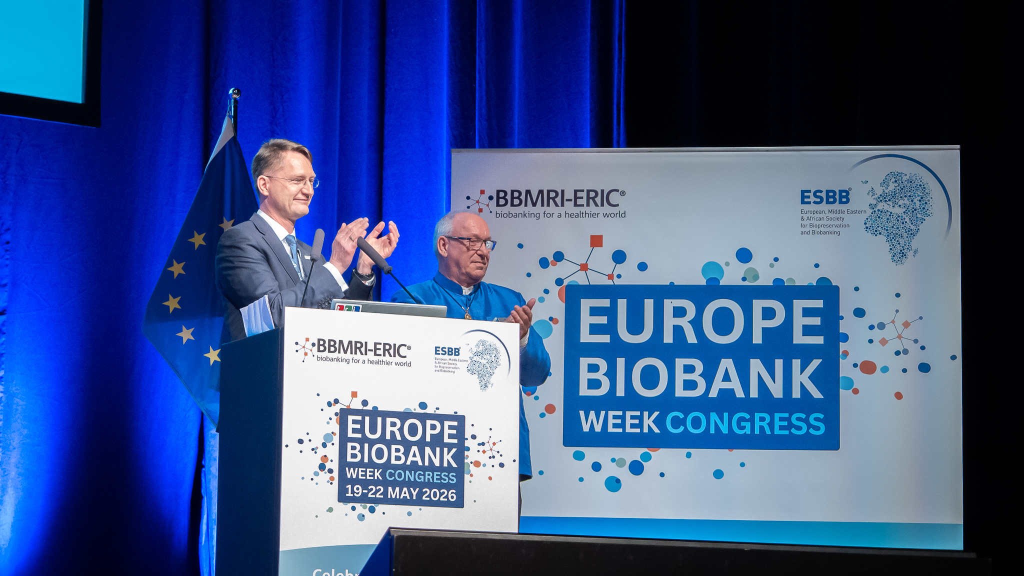 Two man are standing on a stage during EBW26 closing ceremony