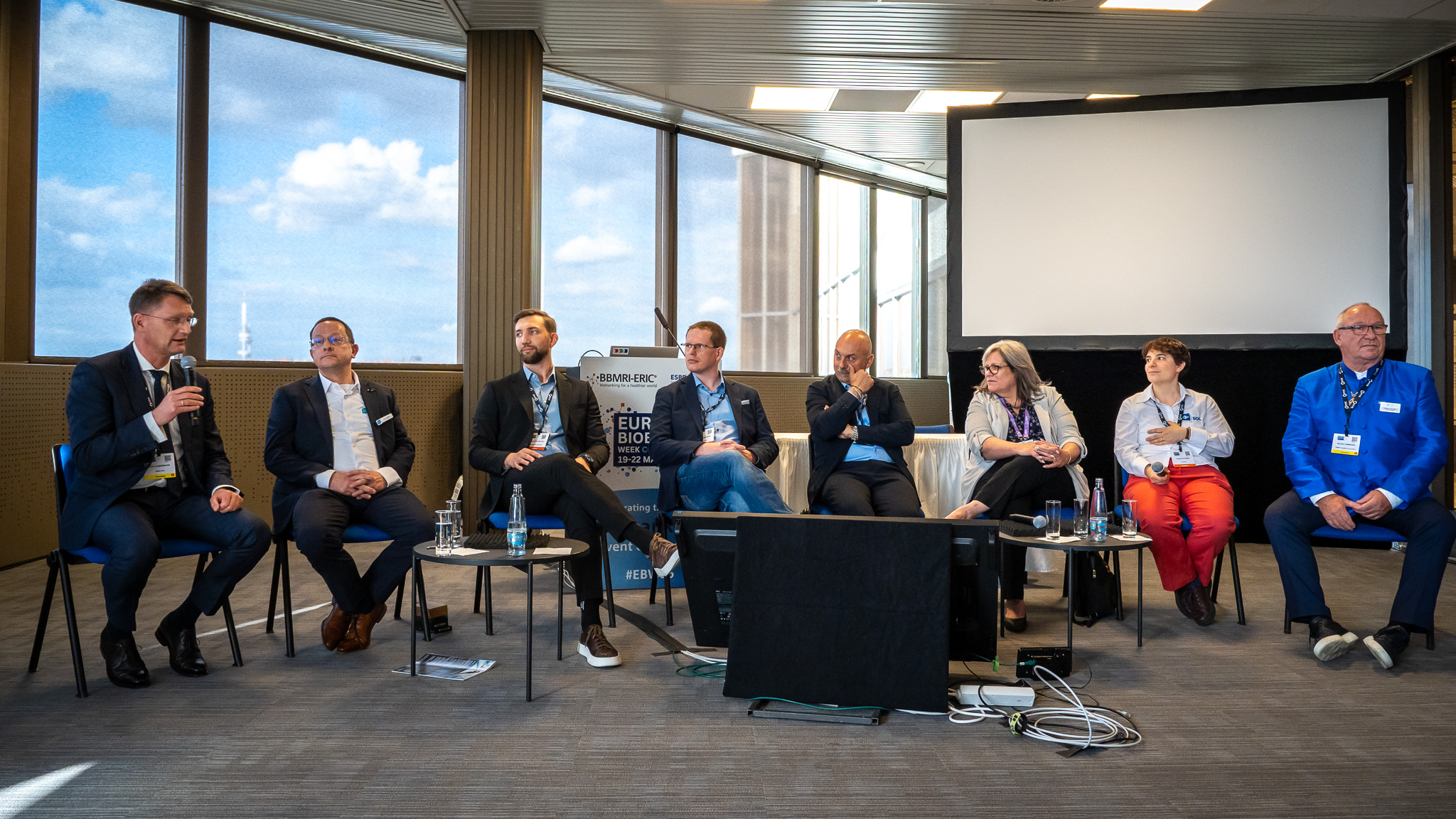 A group of people taking part to a podium discussion